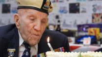 Mr Shelley blows out candles on his birthday cake 