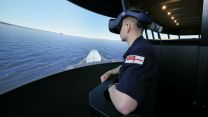 A sailor uses a virtual reality training simulator which accurately recreates the bridge of a warship at HMS Collingwood