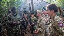 Duchess of Edinburgh listens to a member of personnel speaking 