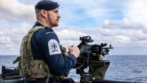 A GPMG gunner from the upper deck crew keeps a lookout as HMS Dragon heads to Cyprus to conduct air defence operations in the Eastern Mediterranean