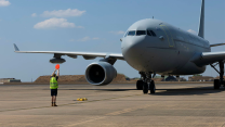 RAF Voyager being marshalled into its parking spot at RAAF Base Darwin by a memeber of the Australian Air Force