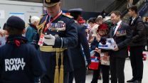 With Minister for Veterans and People, Calvin Bailey raising money just behind him