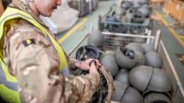 2nd Battalion The Royal Anglian Regiment soldier cuts ties of helmet to prepare it for packaging at MOD Donnington bound for Ukraine 31032022 CREDIT MOD CROWN COPYRIGHT.jpg