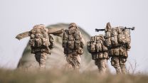 Paras from the mortar platoon make their way across the training area, bergens and weapons slung, regrouping after an airborne drop on Salisbury Plain