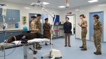 The Princess Royal views a dummy dog used for practice on an operating table during a visit to Kendrew Barracks in Cottesmore (Picture: PA)