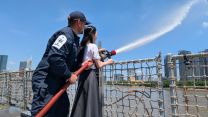 A Ho Chi Minh City schoolgirl is shown how to put out a fire pic MOD