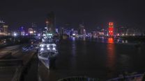 HMS Spey lit up at Saigon Port with the skyline of Ho Chi Minh City in the background pic MOD