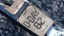 The ship's company forms up on the flight deck on board HMS Dragon to commemorate the 82nd Anniversary of the D-Day Landings in Normandy in June 1944