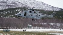A Merlin Mk4 from 845 Naval Air Squadron lowers a shipment of  logs 