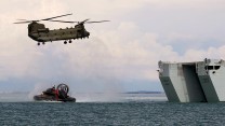 A Chinook and a Royal Marine Hovercraft embark RFA Lyme Bay during Ex Catamaran CREDIT RN