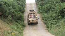 A Jackal Patrol Vehicle experimental hybrid reverses up a steep hill using battery power only at Millbrook Proving Ground.