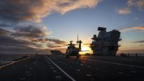 A Merlin Mk2 prepares to lift off from HMS Prince of Wales during aviation trials (Picture: Royal Navy). A Merlin Mk2 prepares to lift off at sunset off the South Coast 20052021 CREDIT ROYAL NAVY.jpg