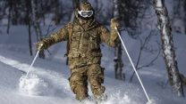 A marine skis through trees