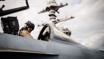 A US pilot assigned to Strike Fighter Squadron conducts pre-flight checks in a FA-18E Super Hornet
