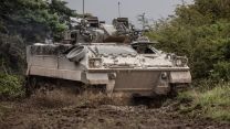A Warrior vehicle manoeuvring through muddy terrain during Exercise IRON CYCLONE 24072023 CREDIT MOD.jpg