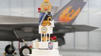 A cake sits in front of an F-35 Lightning stealth jet from 809 Naval Air Squadron during the commissioning ceremony at RAF Marham in Norfolk (Picture: PA Wire, PA Images).