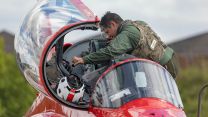 A new member of the RAF Red Arrows looking at the cockpit at RAF Scampton