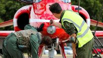 A new pilot flying for the Red Arrows checking over an aircraft at RAF Scampton 