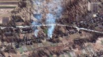 A satellite image shows a Russian convoy near Kyiv, passing burning homes north of Kyiv 28022022 CREDIT Maxar Technologies,REUTERS.jpg