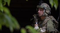 A soldier relays a message during an urban assault on Exercise Iron Cyclone 27072023 CREDIT MOD.jpg