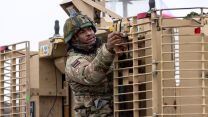 A soldier within 5 Rifles adjusts a Tactical Engagement Simulation (TES) sensor on the back of the Mastiff 22012023 CREDIT MOD Crown Copyright.jpg