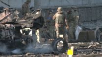 Aftermath of fighting on Kyiv overpass, Ukrainian soldiers look through the debris of battle DATE UNKNOWN CREDIT REUTERS.jpg