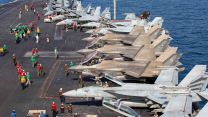 Aircraft attached to Carrier Air Wing 9 sit on the deck of USS Abraham Lincoln in support of Operation Epic Fury 