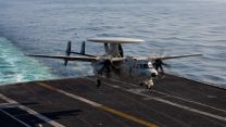An E-2D Hawkeye - an airborne early warning and command and control aircraft - performs an arrested landing