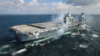 An aerial view of HMS Queen Elizabeth as she carries out a 96 gun salute for the passing of Her Majesty Queen Elizabeth II (Picture: MOD).