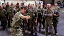 A British soldier briefing French troops inside the vehicle deck of RFA Lyme Bay. (Picture: Royal Navy)