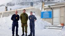 Captain Higham, a member of the Norwegian Forces and Commander L’Amie stand in the snow on the island of Jan Mayen in the Arctic 130422 CREDIT Royal Navy