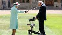 Captain Sir Tom is knighted by the Queen during a ceremony at Windsor Castle (Picture: PA).