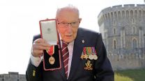 Captain Sir Tom Moore holding medal after he received his knighthood from Queen Elizabeth II during a ceremony at Windsor Castle (Picture: PA).