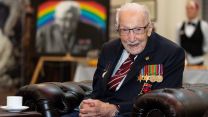 He was pictured with his portrait behind him during the visit (Picture: MOD).