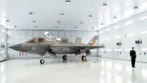 Commanding Officer of 809 Naval Air Squadron Commander Nick Smith with an F-35 Lightning jet during the commissioing ceremony at RAF Marham in King's Lynn in Norfolk (Picture: PA Wire, PA Images).