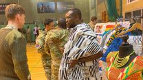 Commonwealh Day Celebration at Baker Barracks, Thorney Island -SSgt Collins explaining his culture and the importance of the dress he's wearing to fellow soldier 14032022 CREDIT BFBS