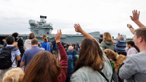 Families and friends waving as Royal Navy's biggest warship arrived at home port 