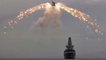 Wildcat fires flares alongside HMS Defender during deployment with CSG21 (Picture: Royal Navy). Flare firing by a British military Wildcat with HMS Defender during deployment with CSG21 21062021 Credit Navy.jpg