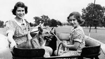 Princess Elizabeth and Princess Margaret pictured together in Windsor in 1941 with a pet dog (Picture: PA Images/Alamy Stock Photo).