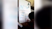 Child drawing on whiteboard