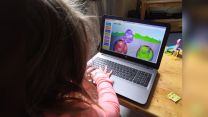 Child playing on laptop