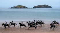 Members of the Household Cavalry, Blues and Royals, exercise their horses along the sands and in the sea at Yellowcraig Beach near North Berwick, East Lothian (Picture: PA NO REUSE)