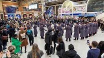 Military band performing in London train station as part of London Poppy Day