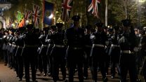 Military personnel carrying out the final full rehearsal of the Coronation at night in London