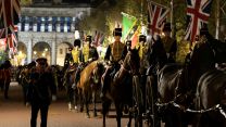 Military personnel carrying out the final full rehearsal of the Coronation at night in London