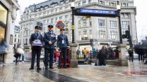 Military personnel standing outside Oxford Circus tube station to fundraise for London Poppy Appeal 