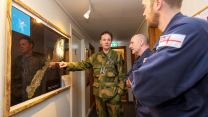 Norwegian personnel point at Jan Mayen map whilst with two Royal Navy personnel 130422 CREDIT Royal Navy