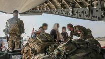 16 Air Assault Brigade soldiers welcome evacuees onto an RAF evacuation flight