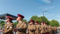 Personnel parade on Salisbury Armed Forces Day under Red Arrows flypast