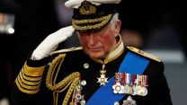 Prince Charles in uniform salutes during HMS Prince of Wales commissioning ceremony at Portsmouth naval base in December 2019 (Picture: Alamy).